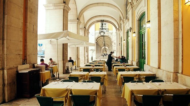 Martinho da Arcada café terrace view with tables and café umbrellas