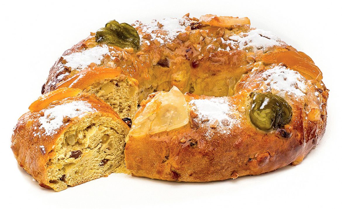 Confeitaria Nacional's King's Cake with candied fruit and powdered sugar on top